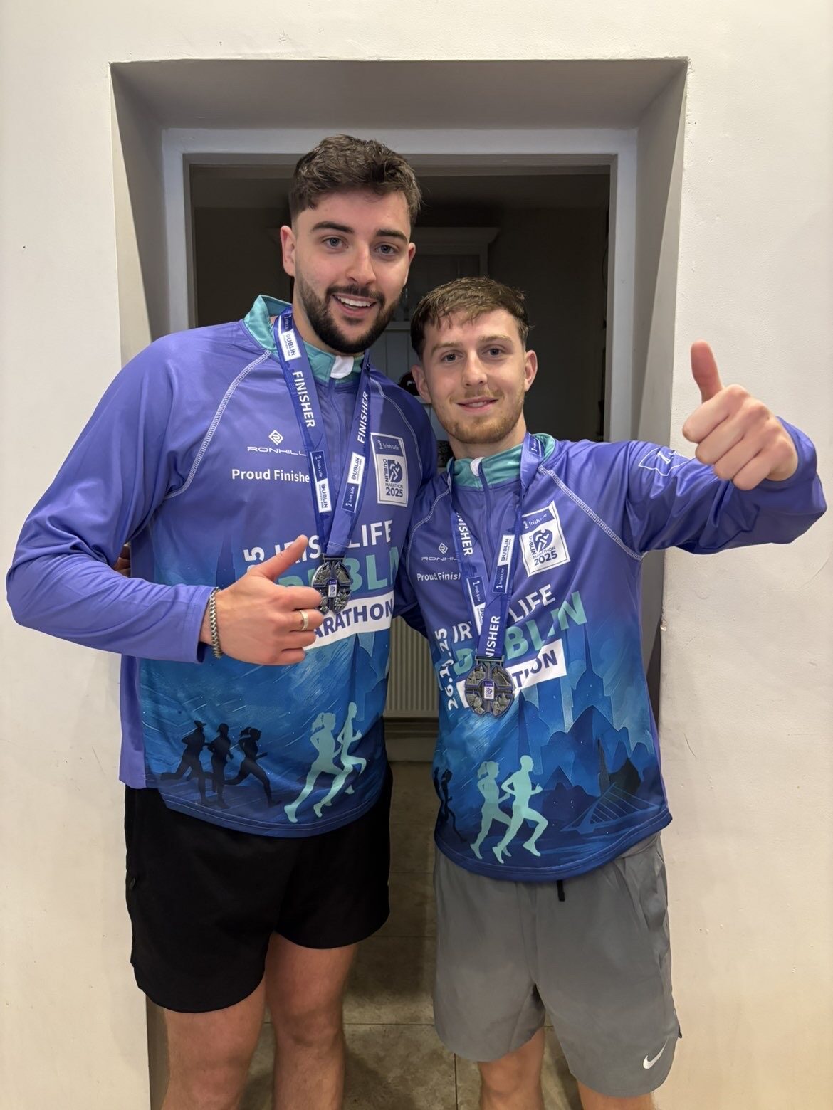 Dan and a friend with their Dublin Marathon finisher medals